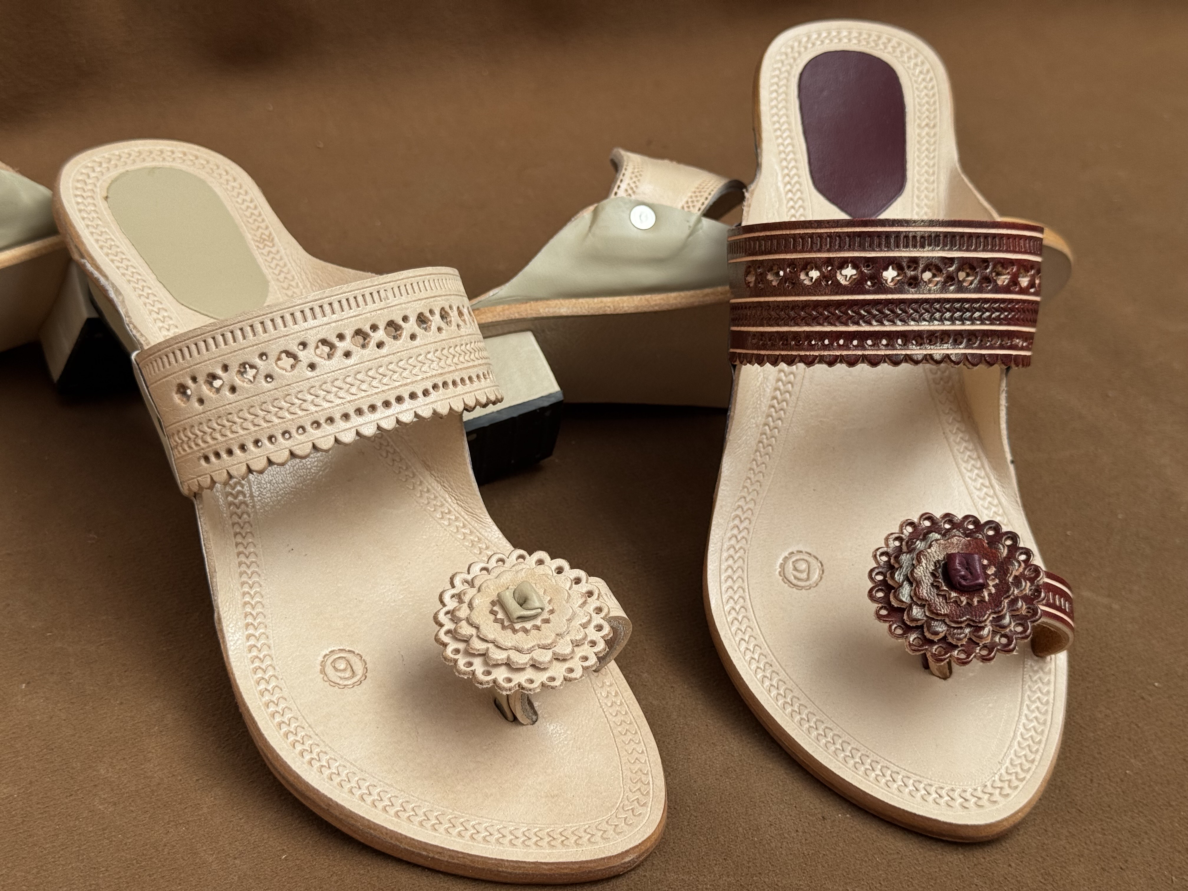 Women leather chappals in natural and maroon shades with carved detailing